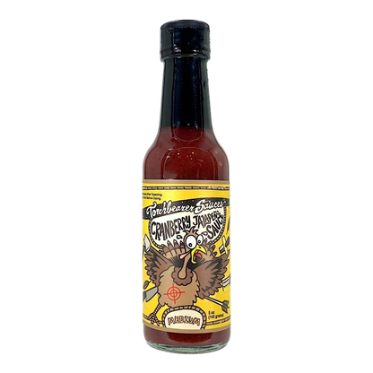 Bottle of cranberry jalapeno hot sauce with a colourful label 
